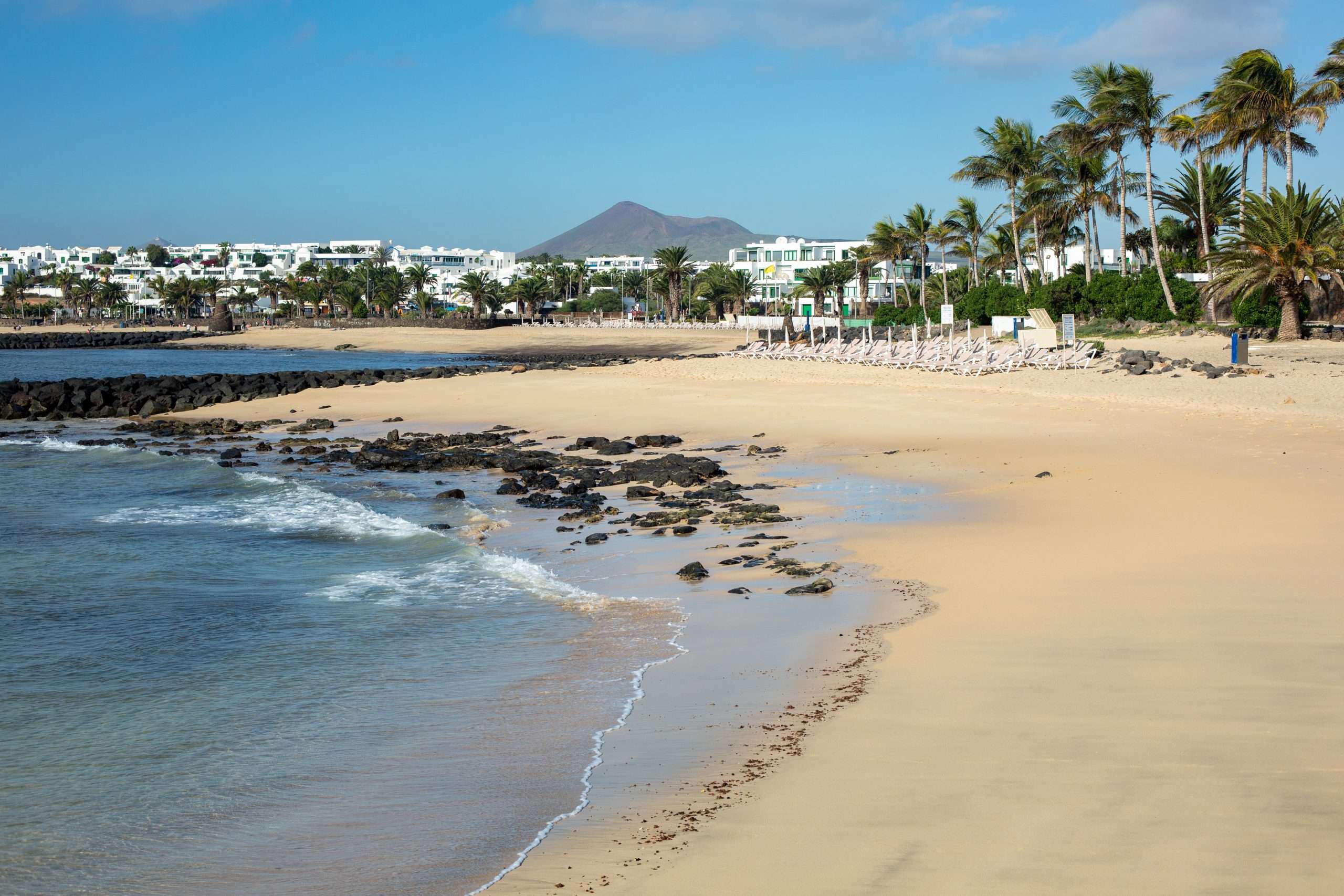 morning ebb on the beach in costa teguise island lanzarote spain scaled